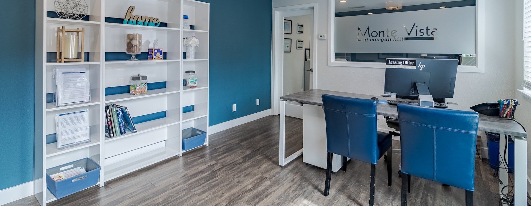 a leasing office with a desk and chairs